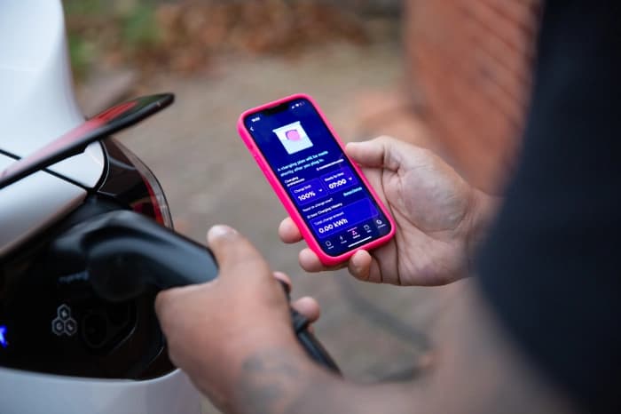 Person using Octopus Energy app while charging EV